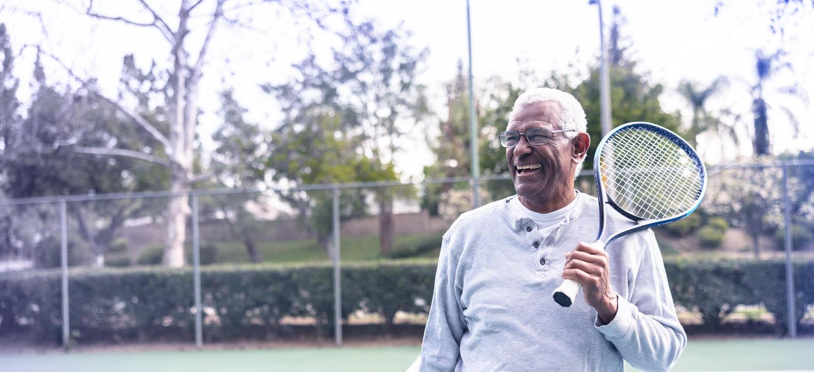 Photo of man holding a tennis racket