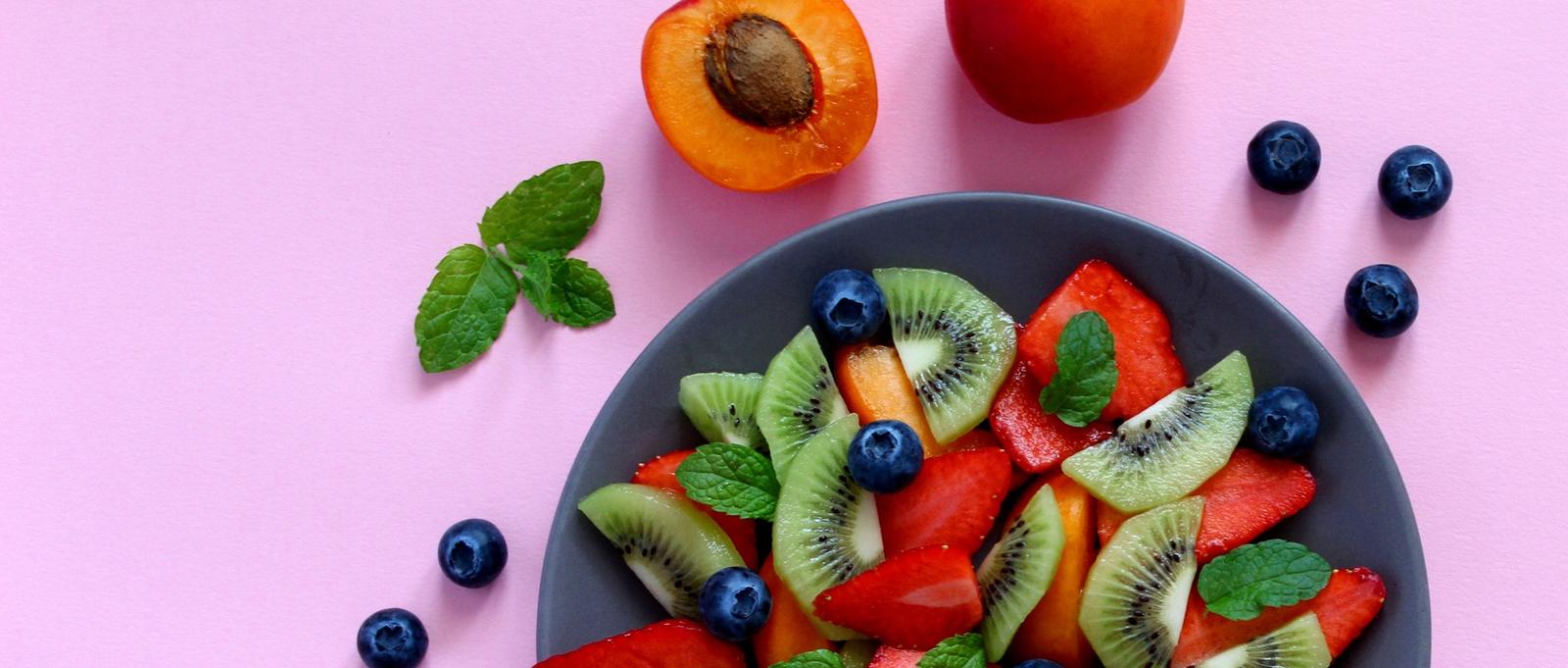 Top view of healthy vegetarian plate on purple background.