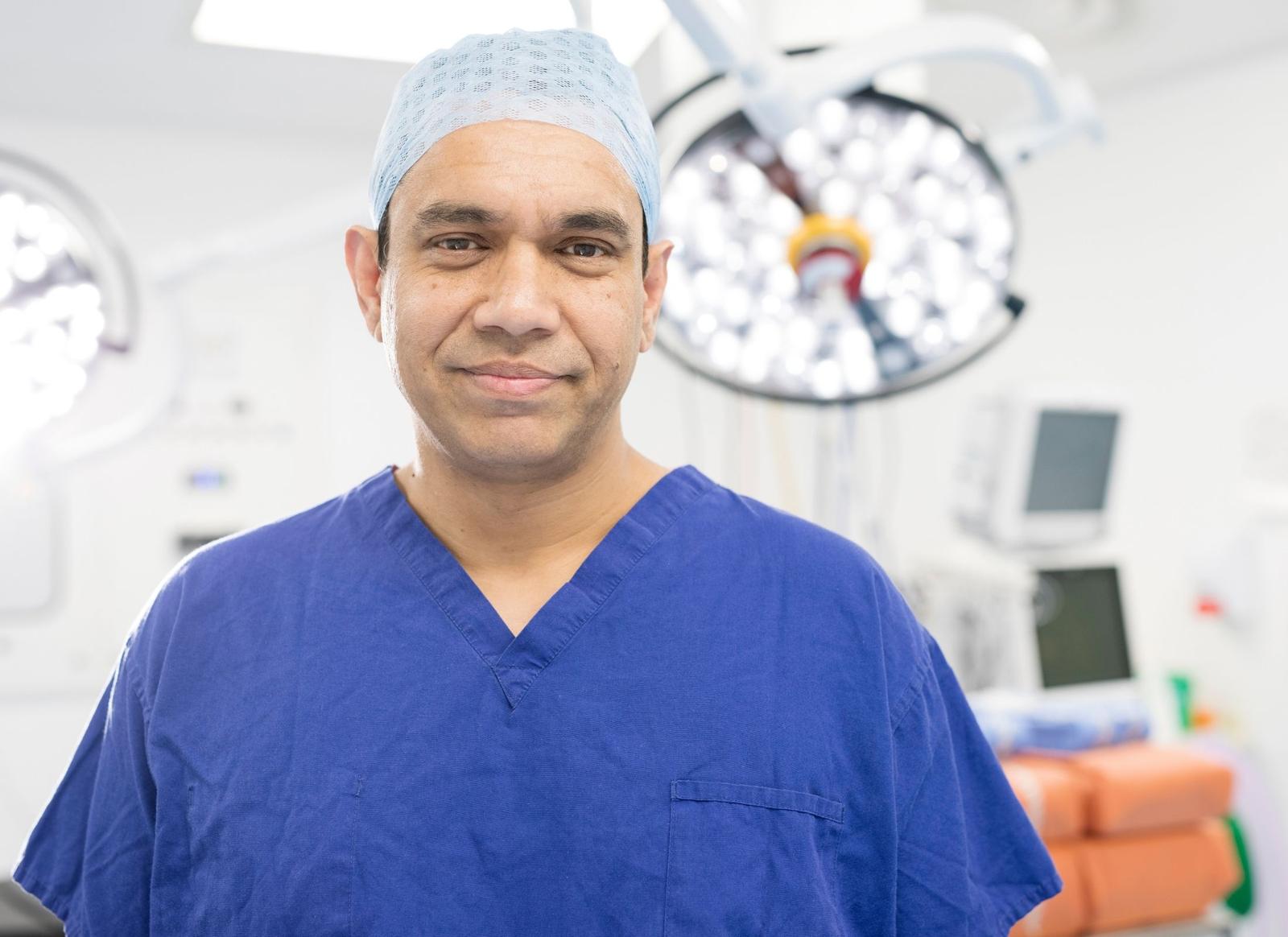 Photo of Dr Nurul Ahad wearing blue medical scrubs