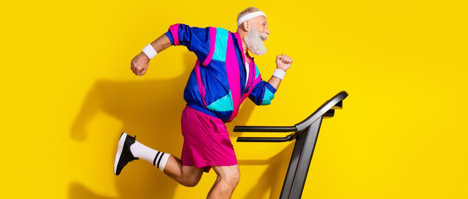 Full length photo of funny aged sportsman run treadmill empty space retro uniform isolated on yellow colour background.