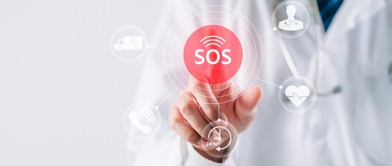 A medical professional touching a digital SOS button surrounded by healthcare icons including ambulance and heartbeat symbols.