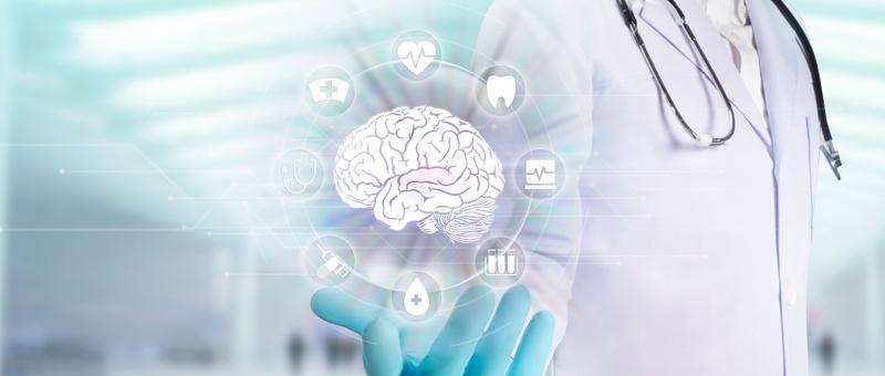 Medical professional in gloves displaying digital brain hologram surrounded by healthcare icons on light blue background.