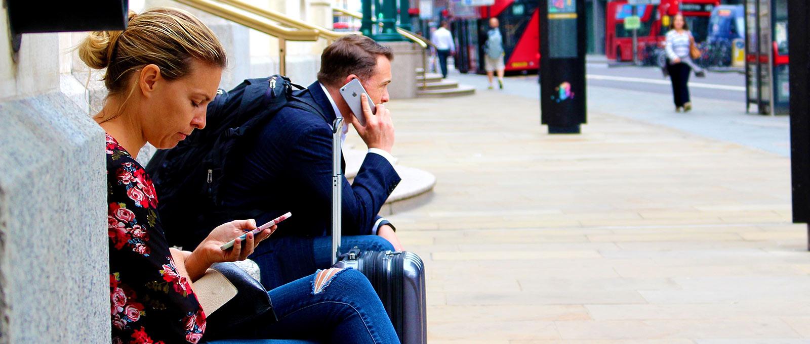 Man and woman on their iphones