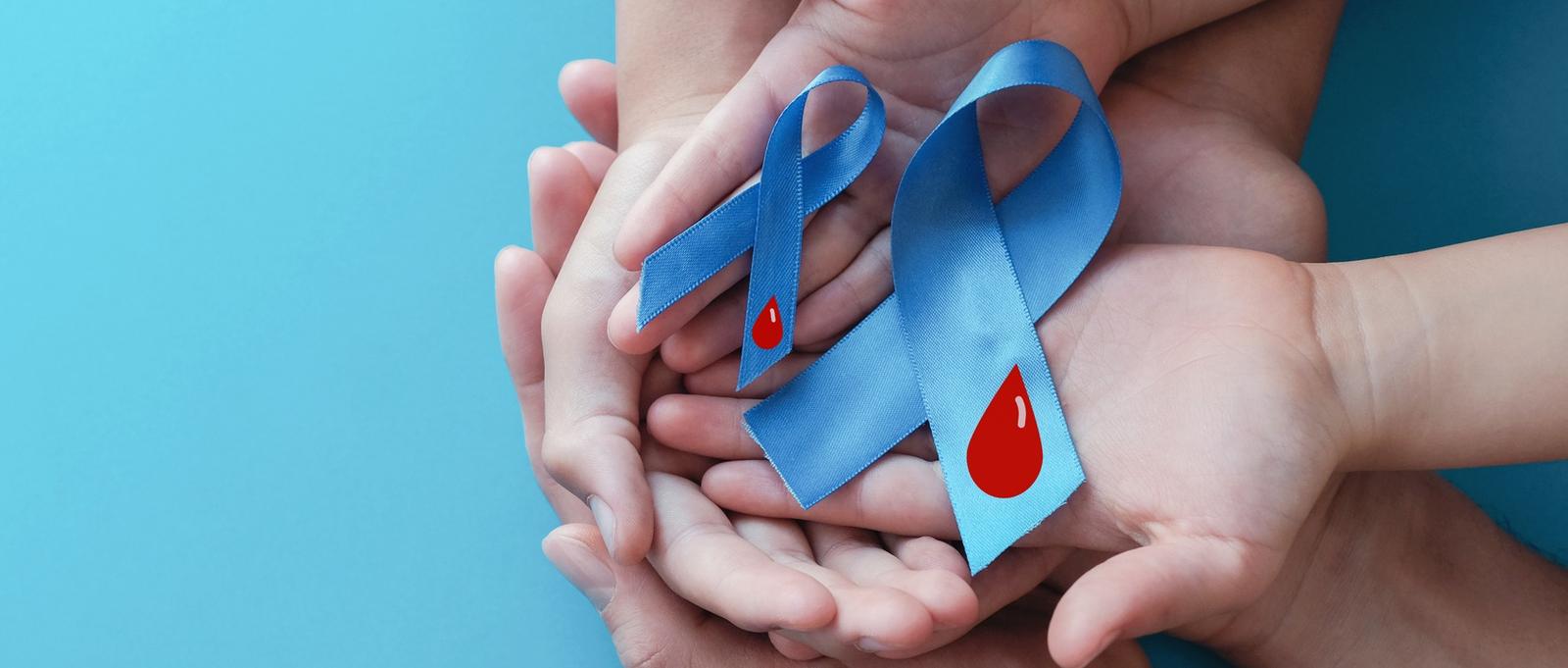Adult and child hands holding light blue ribbons with blood on blue background. Diabetes awareness.